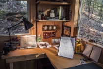 Interior of Martha's writing cabin. On lucky days, a fox or a bear saunters by. Photo Credit: James Gehrt